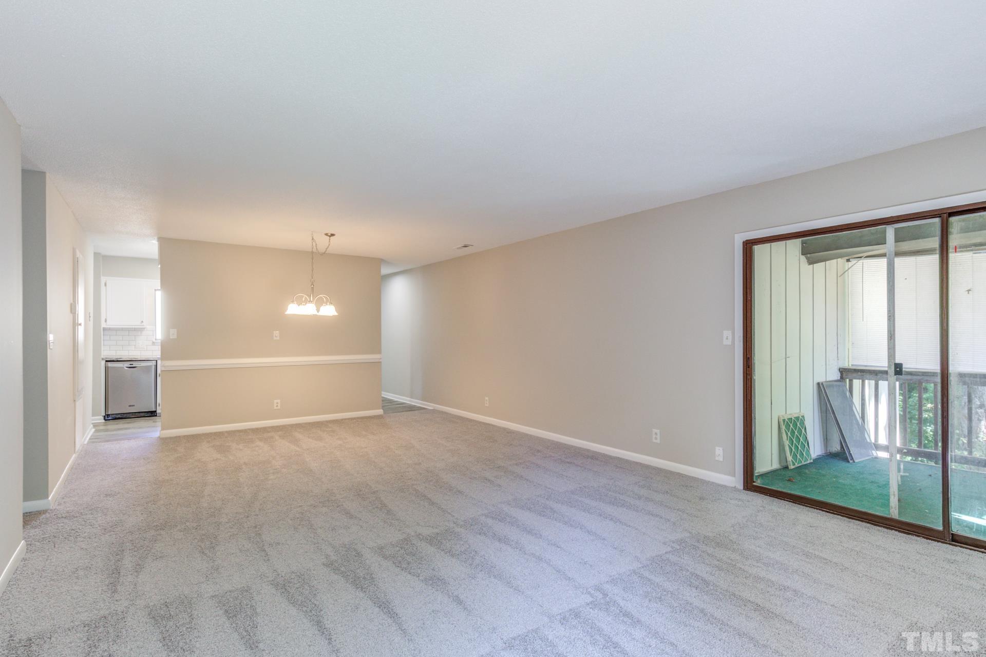 5062 Flint Ridge Place, Unit 5062 Raleigh, NC 27609 - Photo 13 of 23 wooden floor in an empty room with a window