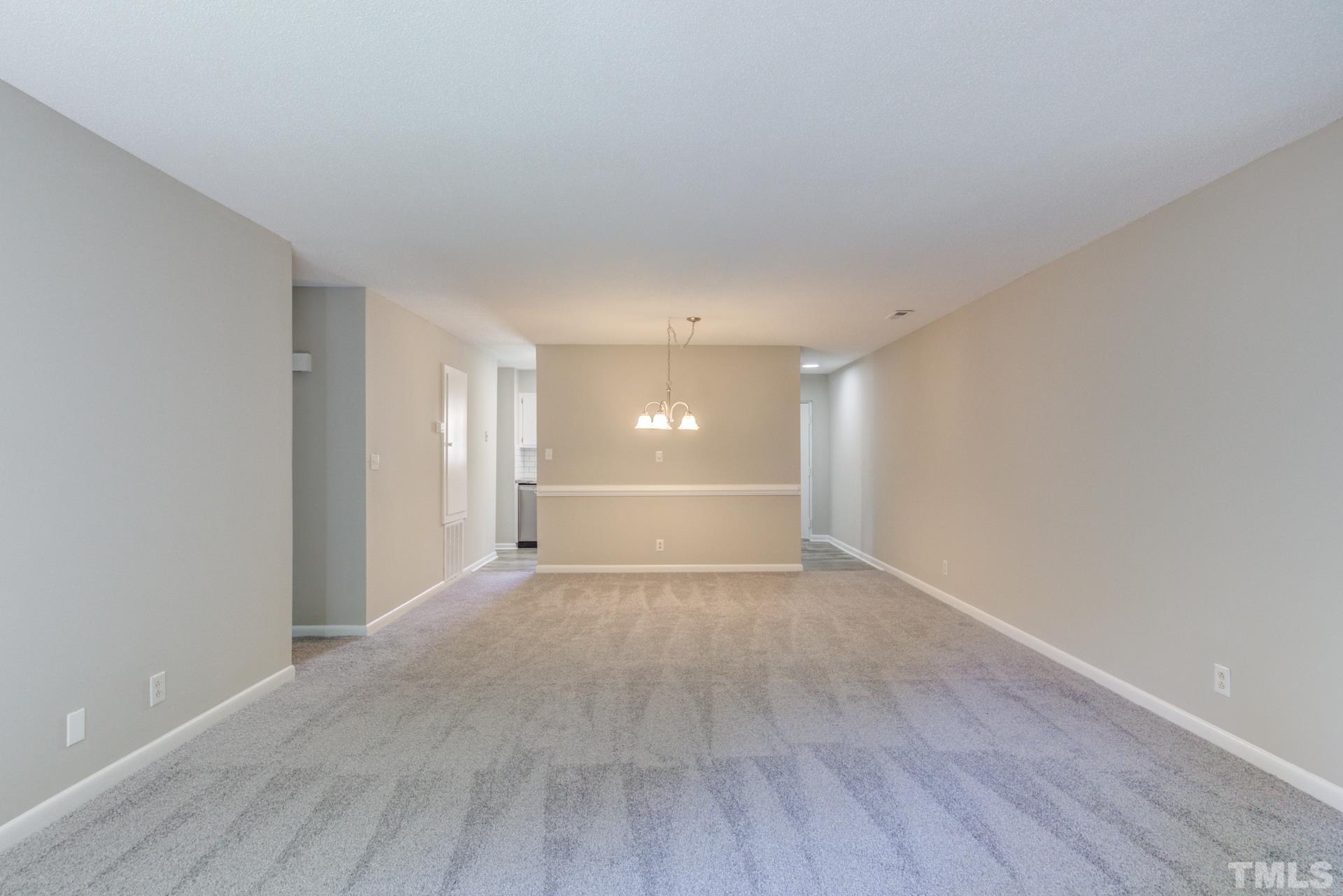 5062 Flint Ridge Place, Unit 5062 Raleigh, NC 27609 - Photo 14 of 23 a view of an empty room with wooden floor