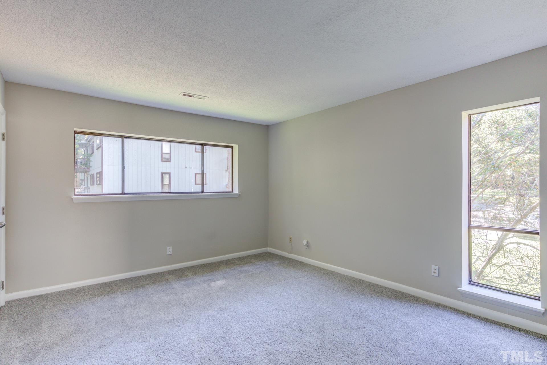 5062 Flint Ridge Place, Unit 5062 Raleigh, NC 27609 - Photo 15 of 23 an empty room with windows