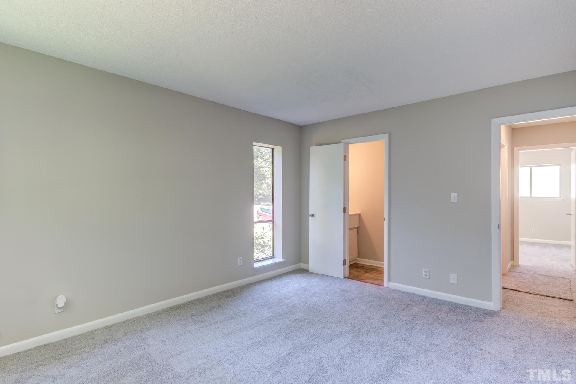 5062 Flint Ridge Place, Unit 5062 Raleigh, NC 27609 - Photo 17 of 23 an empty room with windows and closet