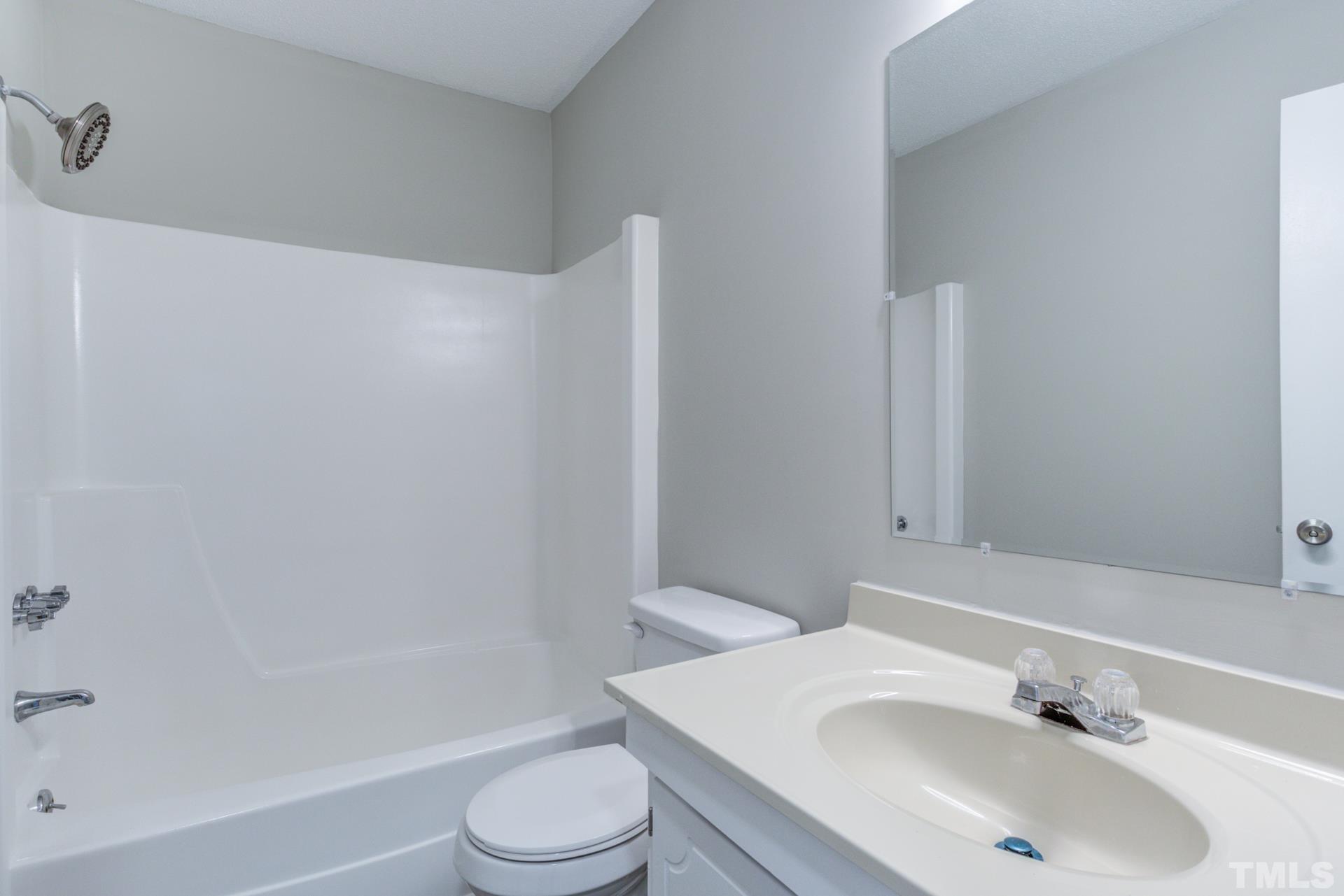 5062 Flint Ridge Place, Unit 5062 Raleigh, NC 27609 - Photo 22 of 23 a bathroom with a sink toilet and shower
