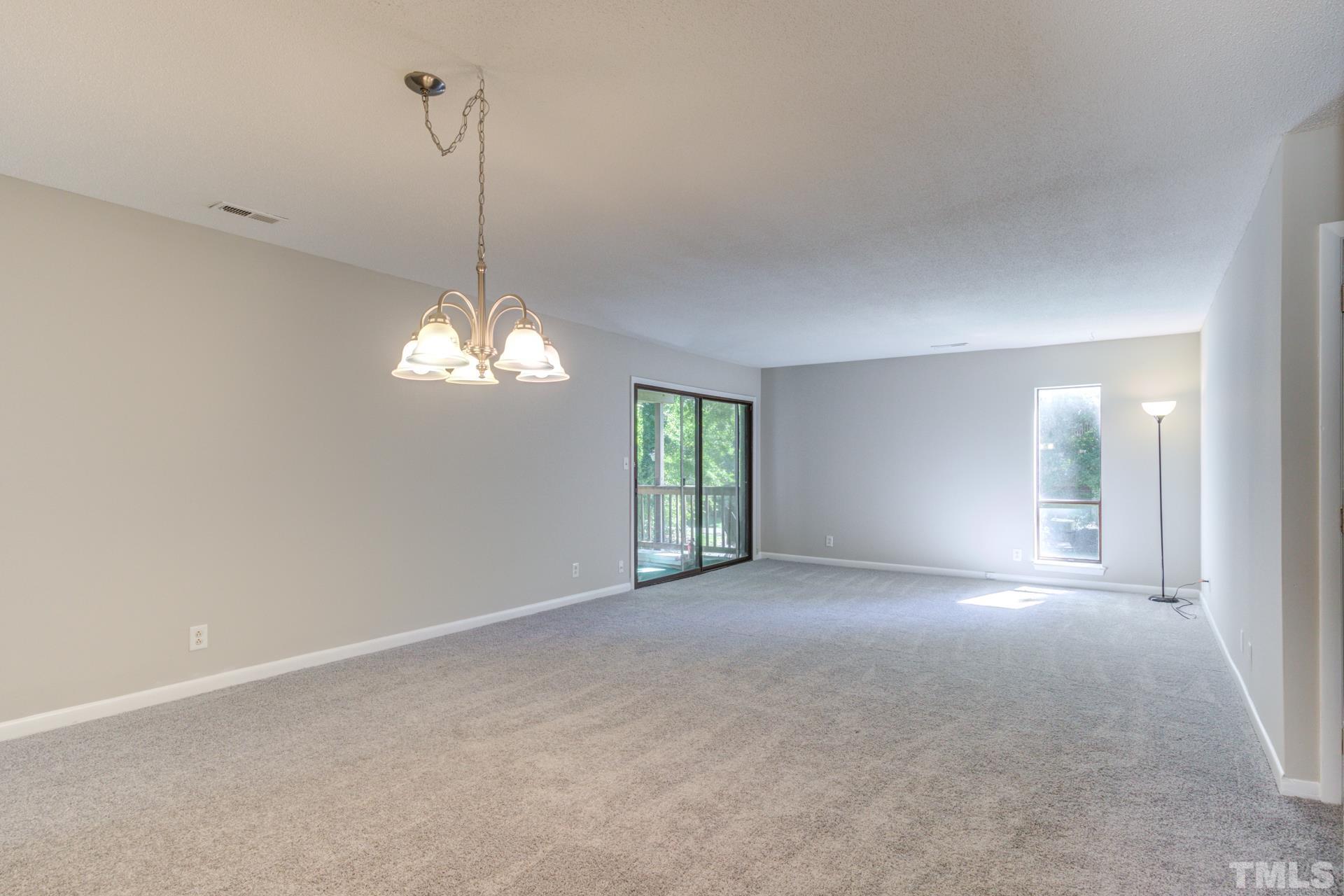 5062 Flint Ridge Place, Unit 5062 Raleigh, NC 27609 - Photo 8 of 23 a view of a room with windows and chandelier