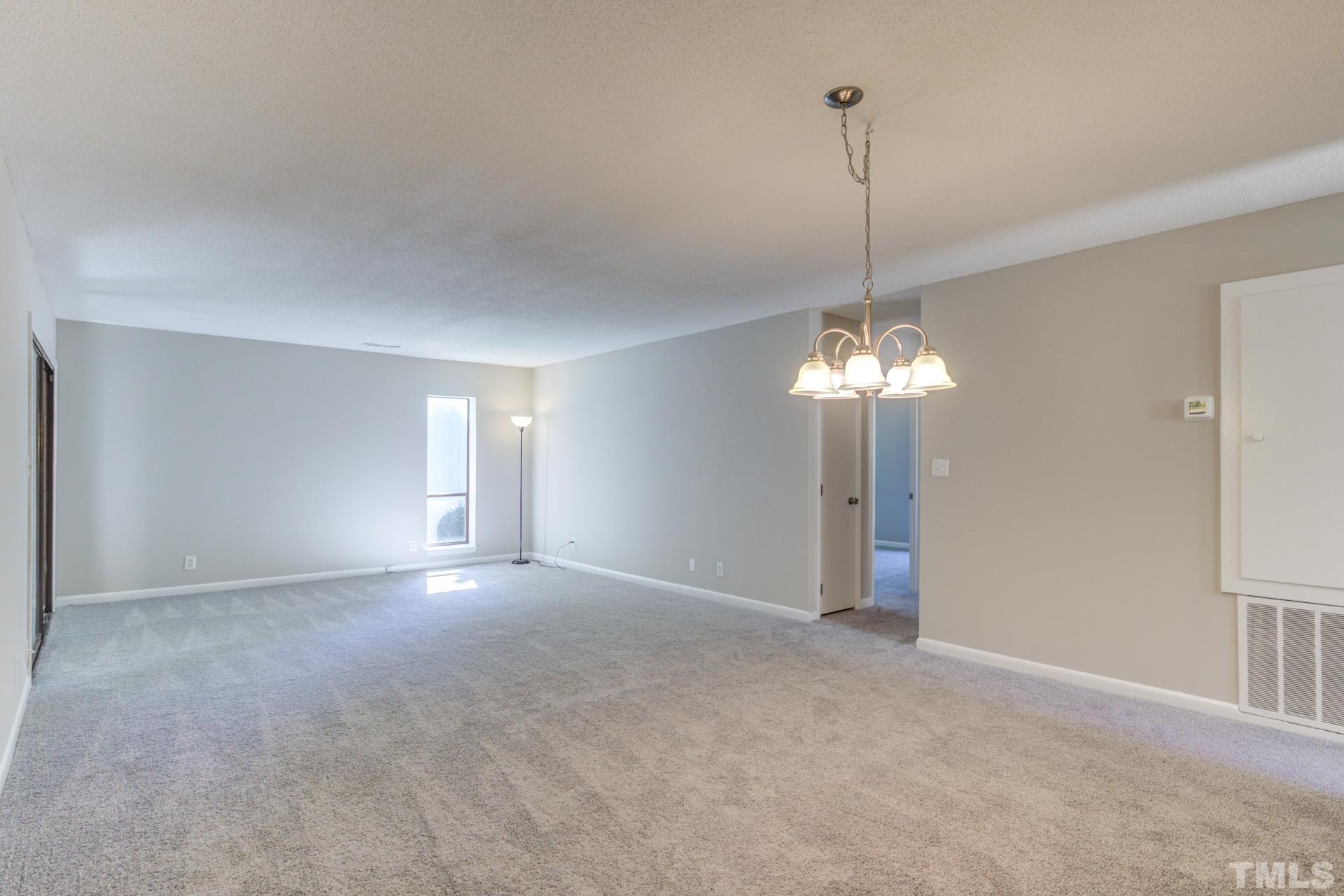 5062 Flint Ridge Place, Unit 5062 Raleigh, NC 27609 - Photo 9 of 23 a view of a room with a chandelier fan