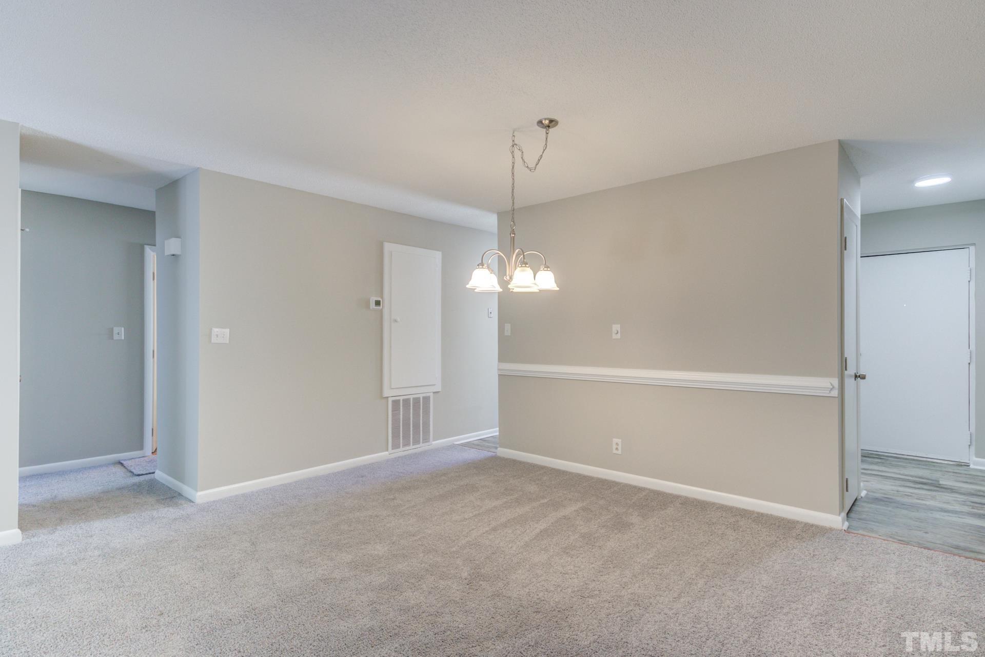 5062 Flint Ridge Place, Unit 5062 Raleigh, NC 27609 - Photo 10 of 23 a view of an empty room with chandelier fan
