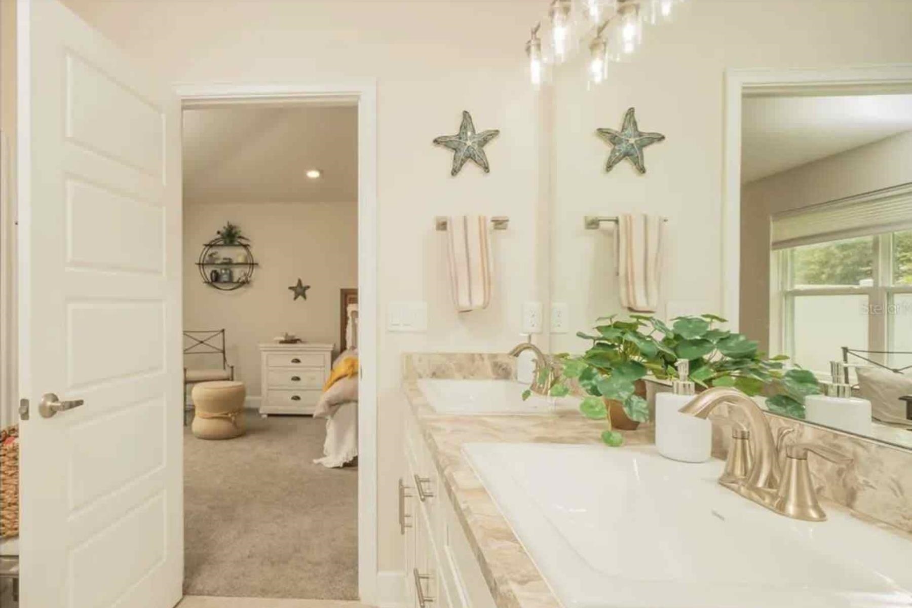 25 Rivertown Road Palm Coast, FL 32137 - Photo 21 of 40 a bathroom with a tub sink and mirror