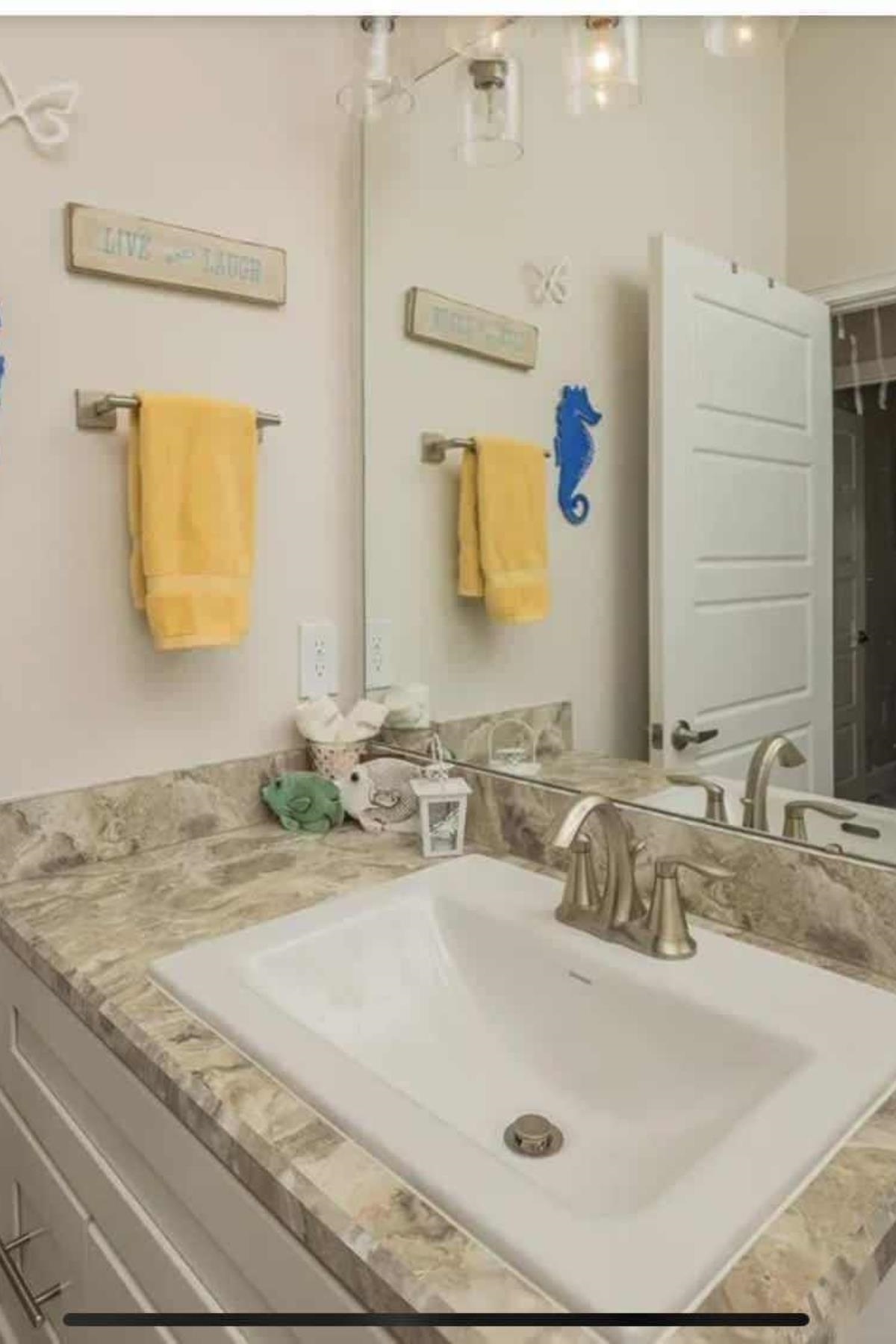 25 Rivertown Road Palm Coast, FL 32137 - Photo 24 of 40 a bathroom with a sink and a mirror