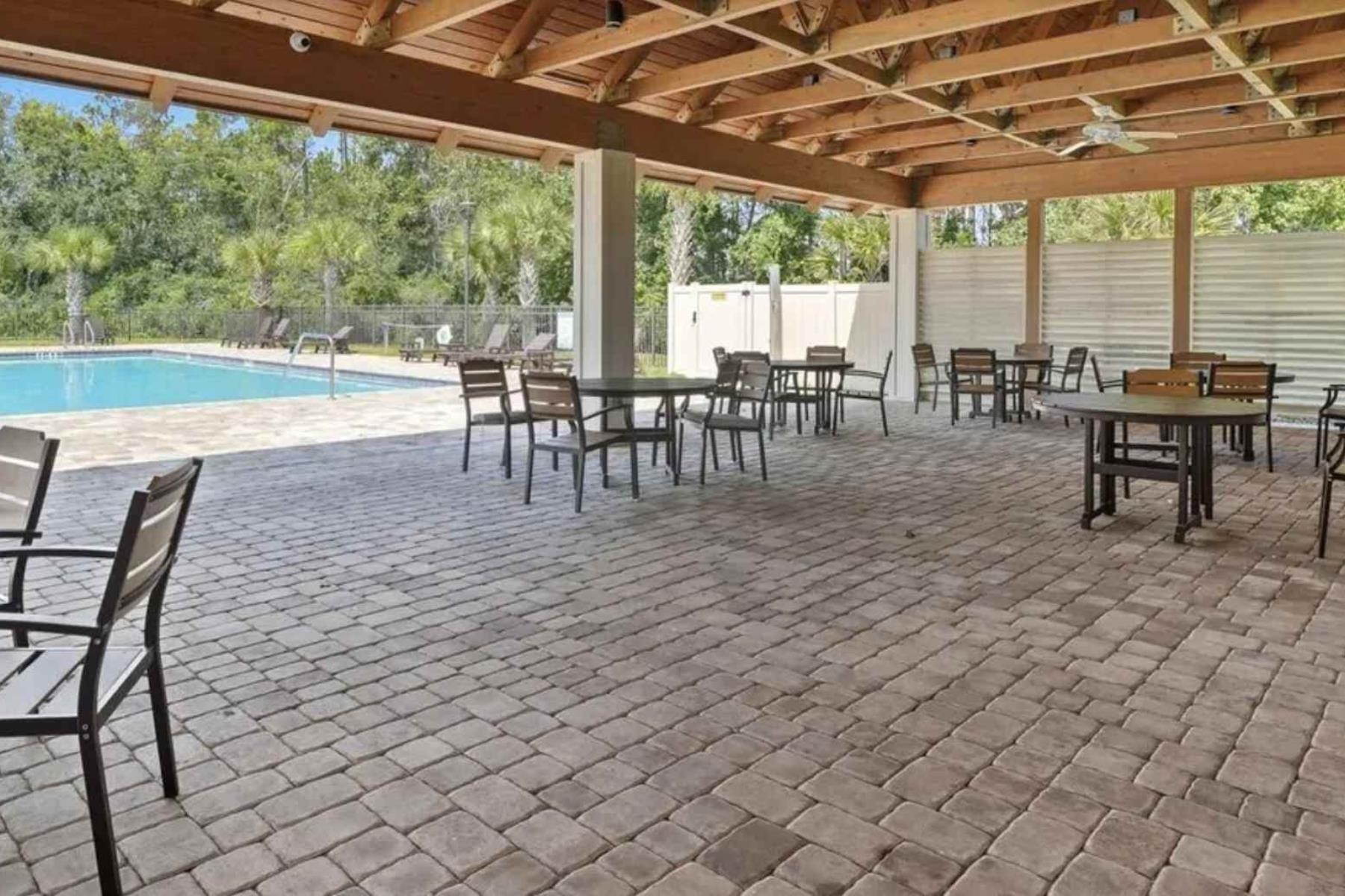 25 Rivertown Road Palm Coast, FL 32137 - Photo 38 of 40 a dining room with furniture and a garden view