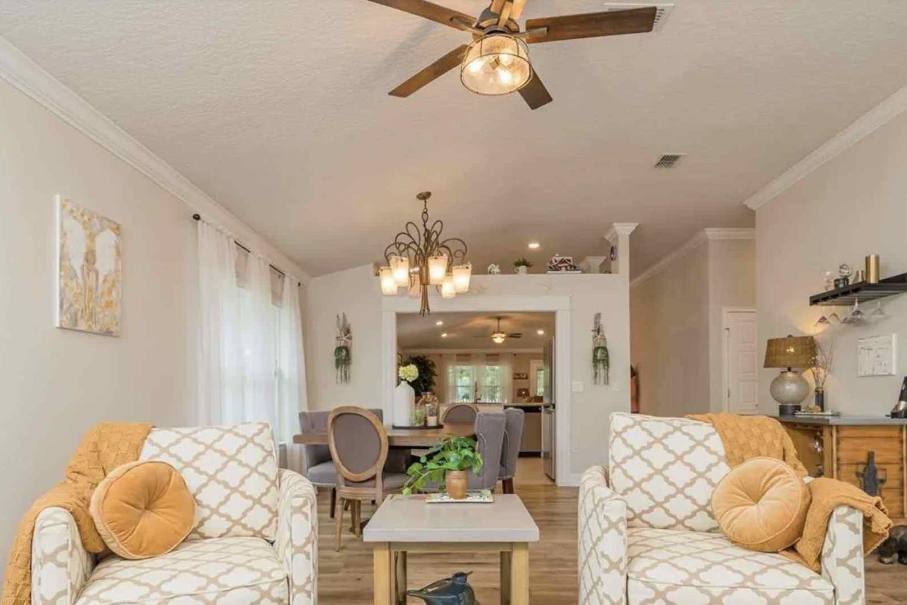 25 Rivertown Road Palm Coast, FL 32137 - Photo 8 of 40 a living room with furniture and a chandelier