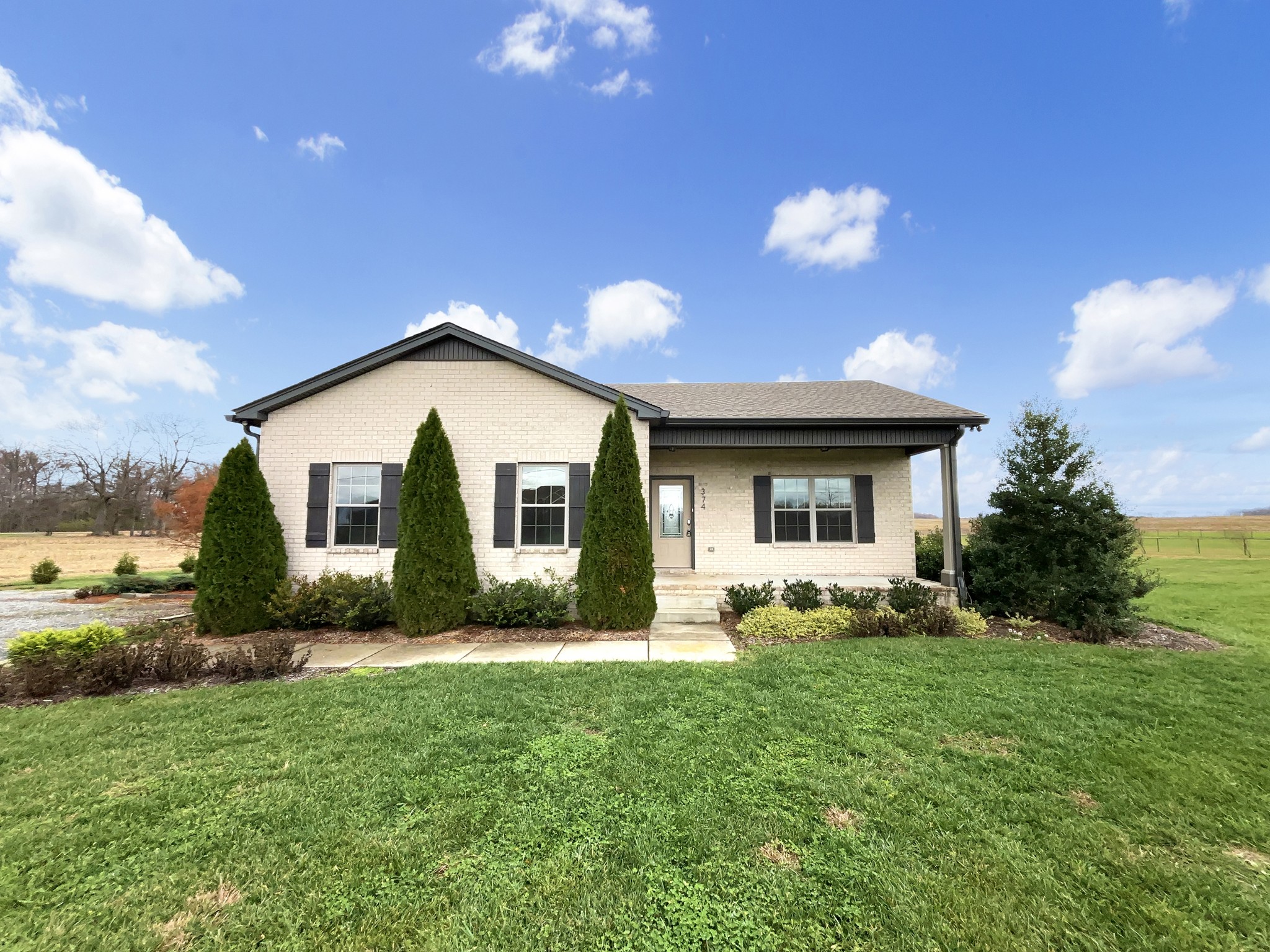 a front view of house with yard and green space