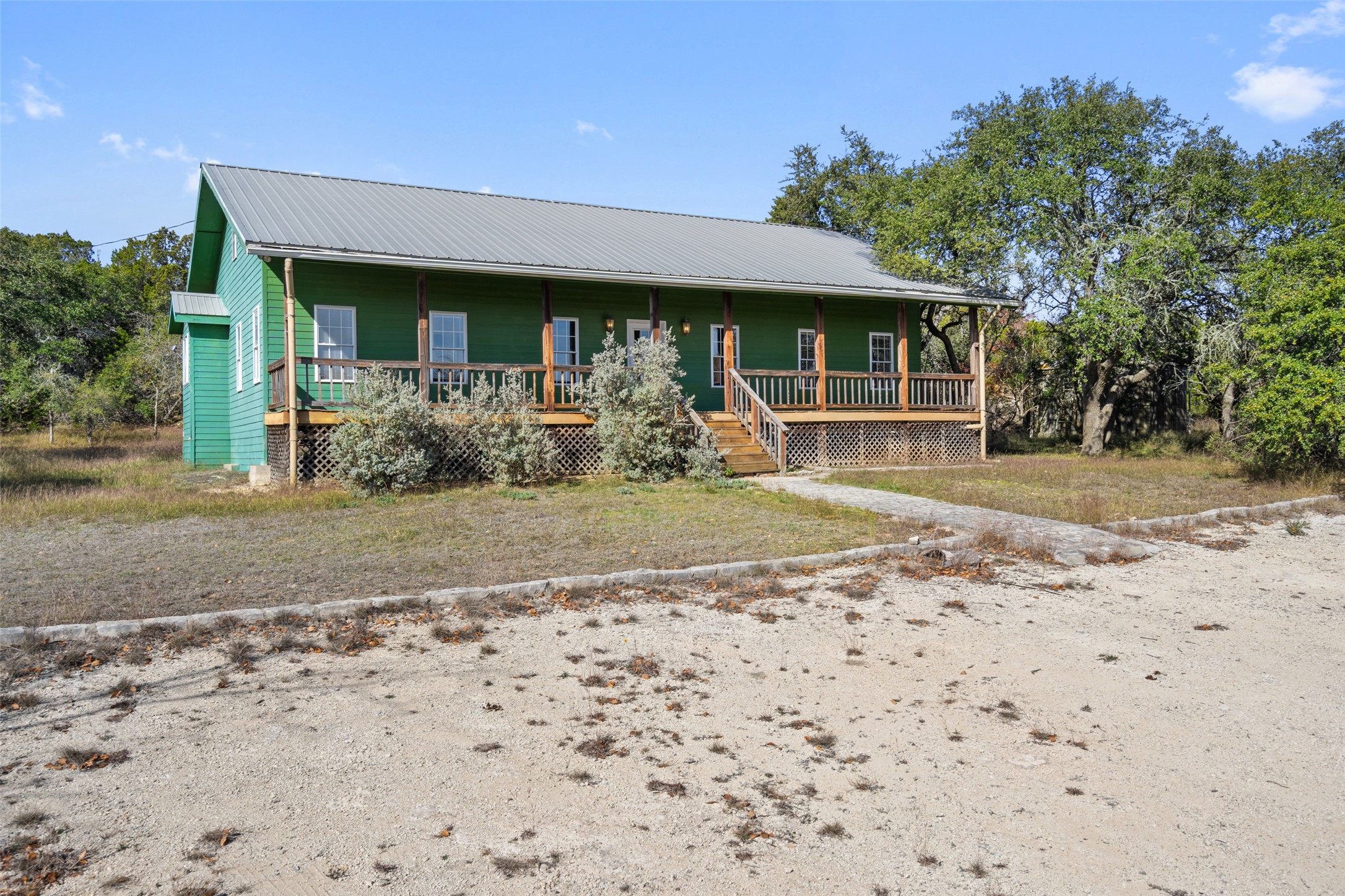1401 Pursley Road Dripping Springs, TX 78620 - Photo 4 of 35 View of front of home with a porch and a metal roof