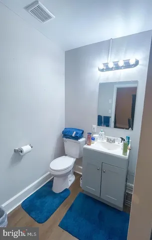 a bathroom with a sink a toilet and mirror