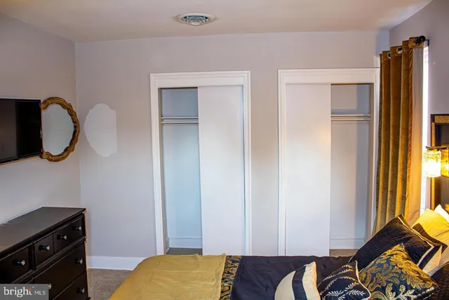 a bedroom with a bed and a dresser