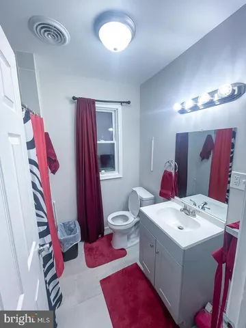 a bathroom with a sink vanity and mirror
