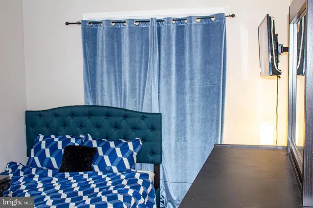 a black and white cabinet with wooden floor