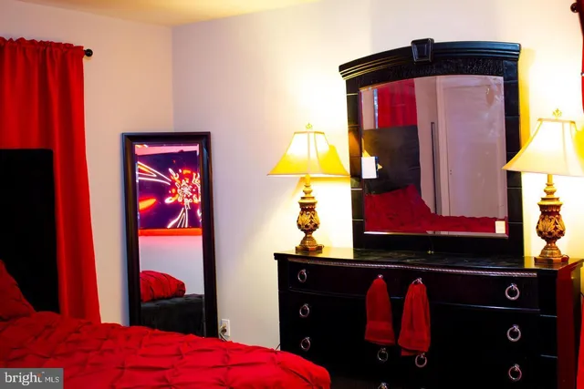 a bedroom with a bed and a lamp