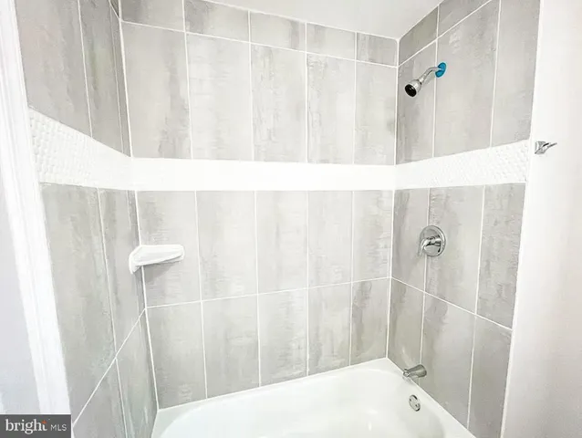 a bathroom with a shower and a tub