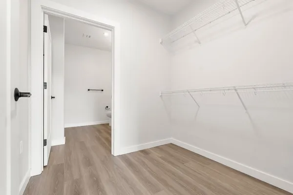a view of a room with wooden floor