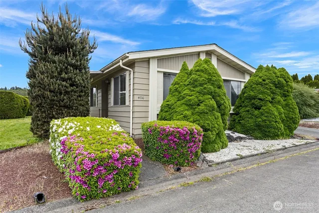 a front view of house with flowers