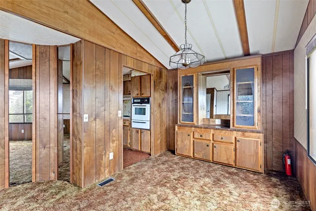 a kitchen with stainless steel appliances granite countertop a sink a stove a refrigerator and cabinets