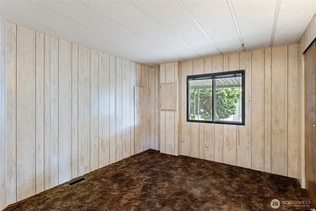 an empty room with windows and closet