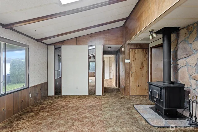 a room with stainless steel appliances kitchen island granite countertop furniture and a view of living room