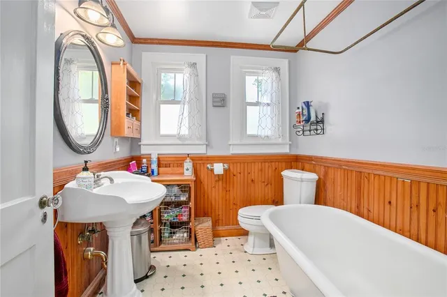 a bedroom with furniture and a wooden floor