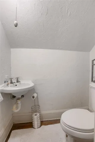 a view of a room with wooden floor and windows