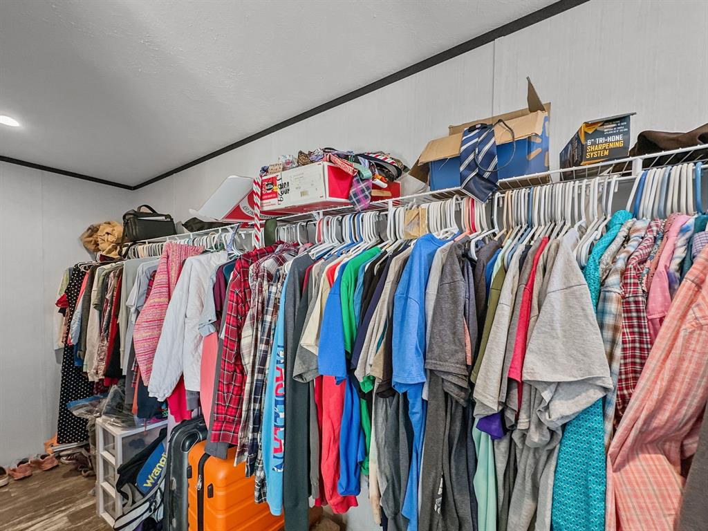 303 Mesa Ridge Decatur, TX 76234 - Photo 11 of 21 a view of walk in closet with clothes