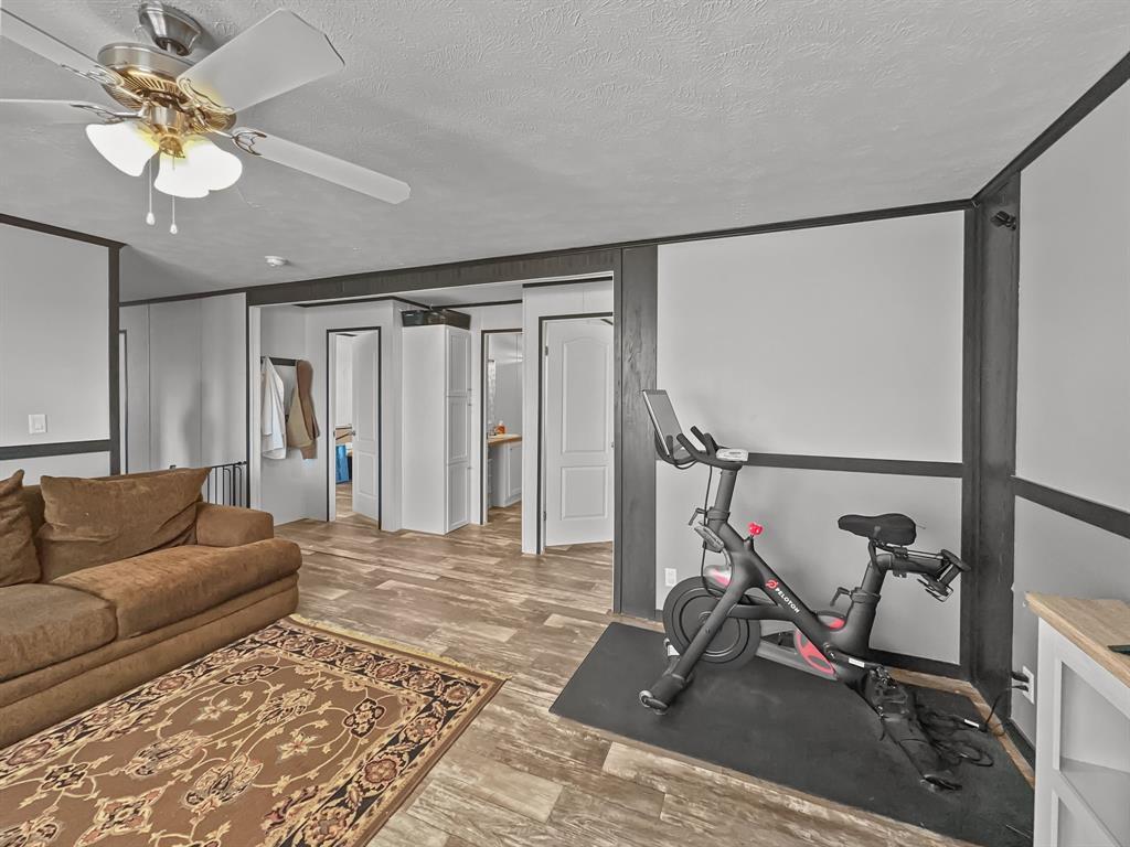 303 Mesa Ridge Decatur, TX 76234 - Photo 12 of 21 a view of a livingroom with furniture and a gym equipment