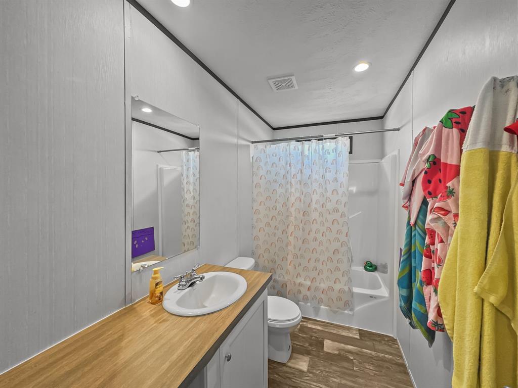 303 Mesa Ridge Decatur, TX 76234 - Photo 13 of 21 a bathroom with a sink toilet and shower