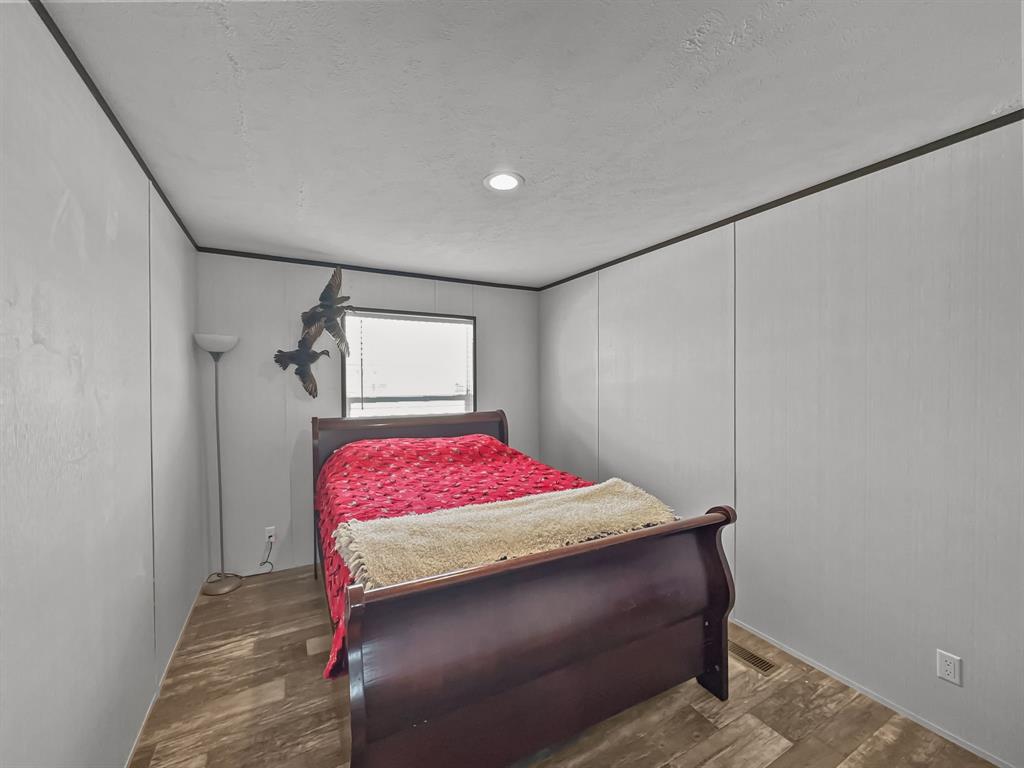 303 Mesa Ridge Decatur, TX 76234 - Photo 14 of 21 a bedroom with a bed and a mirror