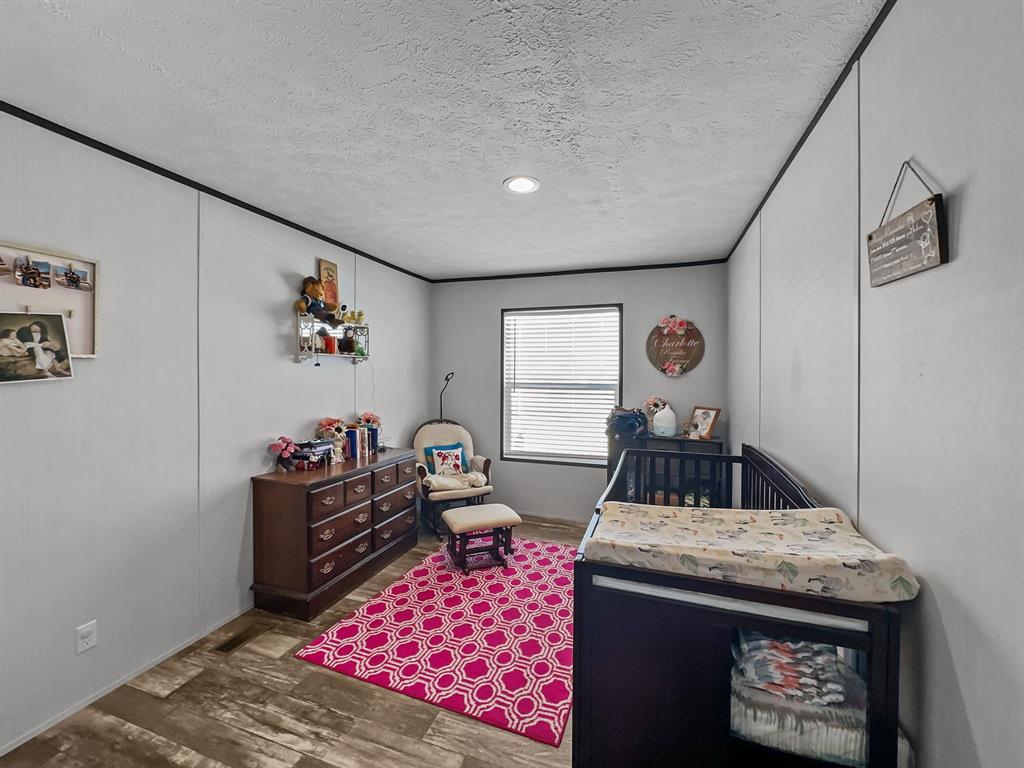 303 Mesa Ridge Decatur, TX 76234 - Photo 16 of 21 a living room with furniture and a rug