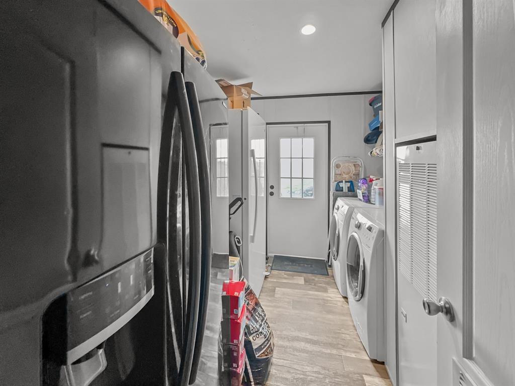 303 Mesa Ridge Decatur, TX 76234 - Photo 17 of 21 a walk in closet with wooden floor and a bathroom