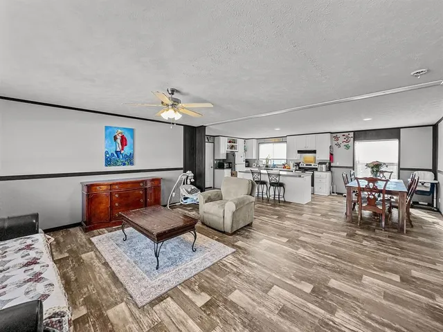 a living room with furniture and a view of dining room