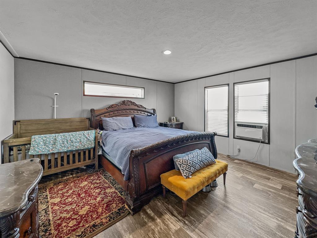 303 Mesa Ridge Decatur, TX 76234 - Photo 8 of 21 a bedroom with a bed and wooden floor