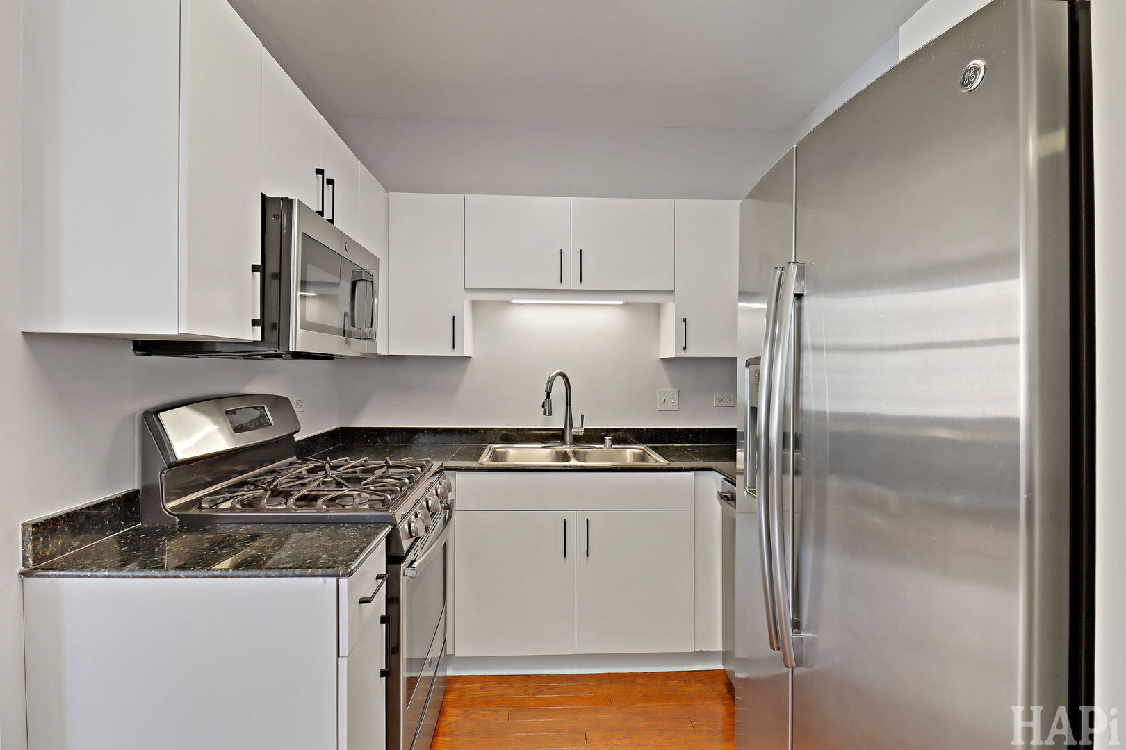 21 West Chestnut Street, Unit 1509 Chicago, IL 60610 - Photo 13 of 34 a kitchen with stainless steel appliances granite countertop a stove a refrigerator and a microwave