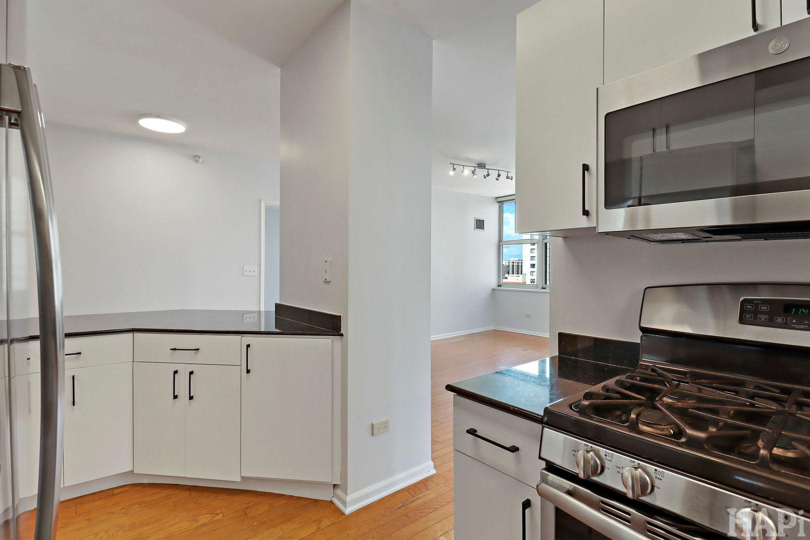 21 West Chestnut Street, Unit 1509 Chicago, IL 60610 - Photo 16 of 34 a kitchen with white cabinets and appliances