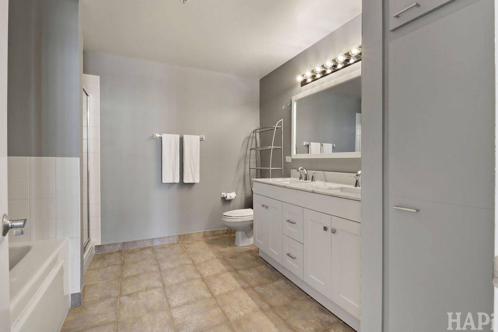 21 West Chestnut Street, Unit 1509 Chicago, IL 60610 - Photo 25 of 34 a spacious bathroom with a double vanity sink a mirror and a bathtub