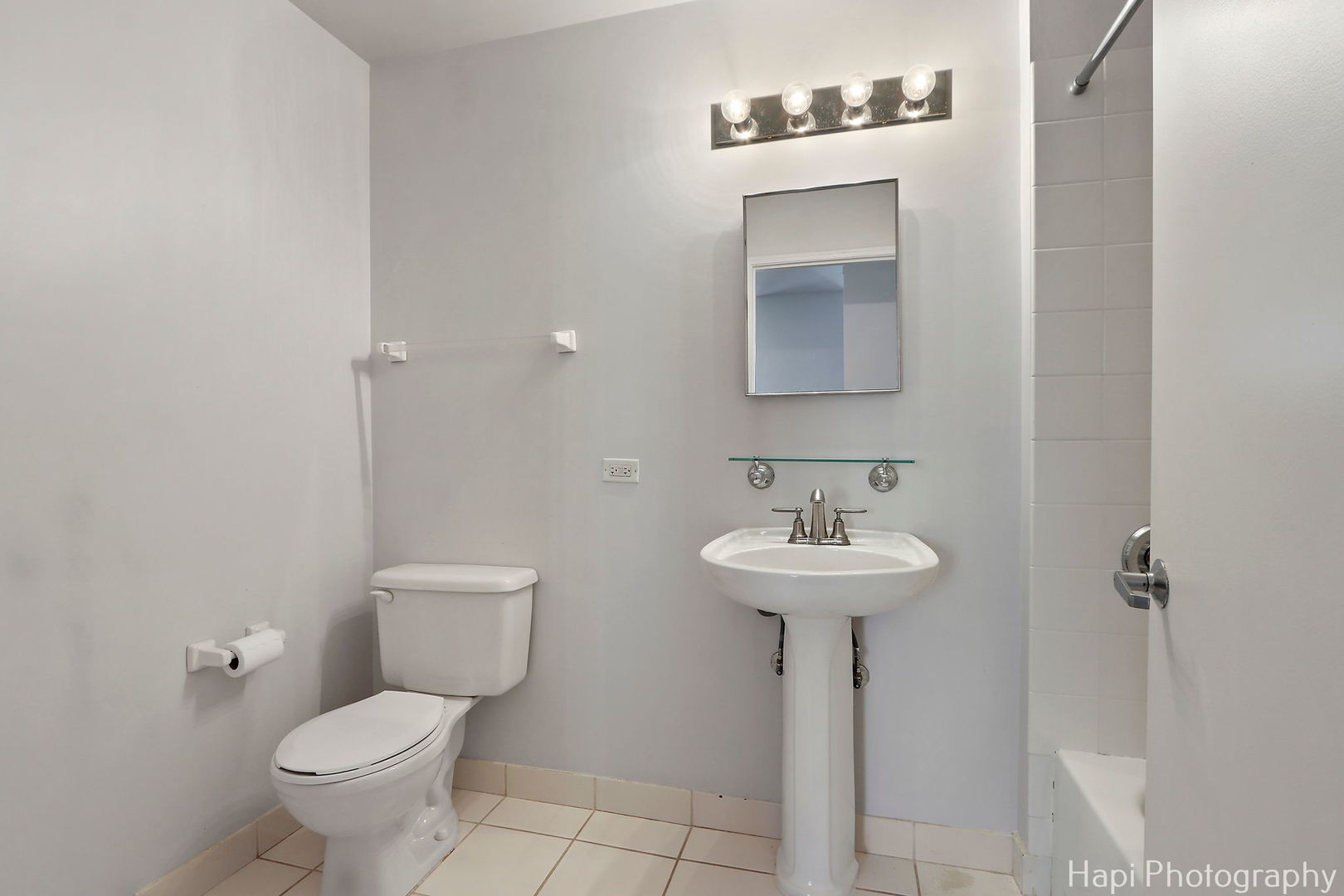21 West Chestnut Street, Unit 1509 Chicago, IL 60610 - Photo 31 of 34 a bathroom with a sink toilet and a mirror