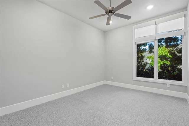 a view of room with window and ceiling fan