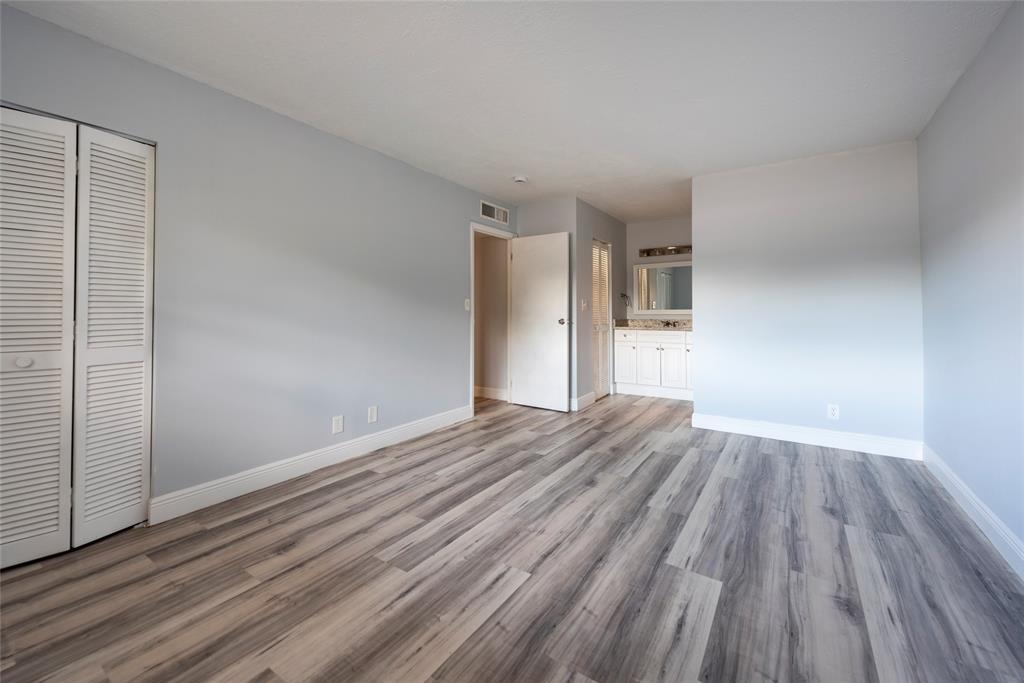 6061 North Falls Cir Drive, Unit 102 Lauderhill, FL 33319 - Photo 17 of 26 an empty room with wooden floor and windows