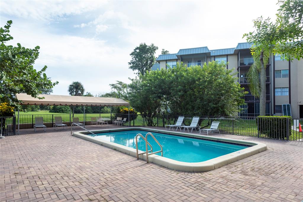 6061 North Falls Cir Drive, Unit 102 Lauderhill, FL 33319 - Photo 24 of 26 a view of a swimming pool with a patio
