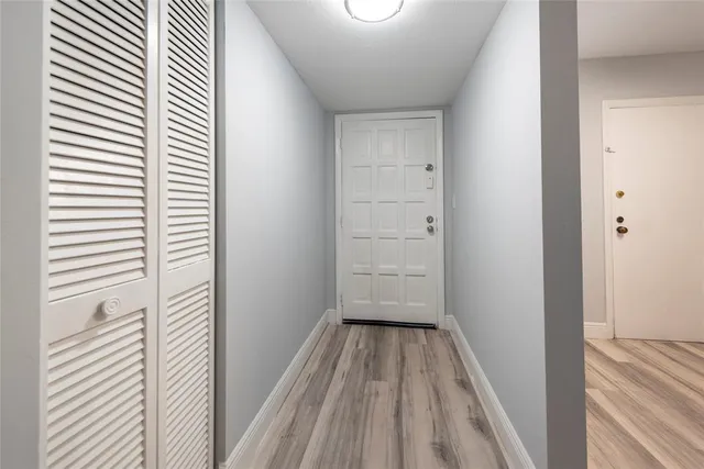 a view of a room with wooden floor
