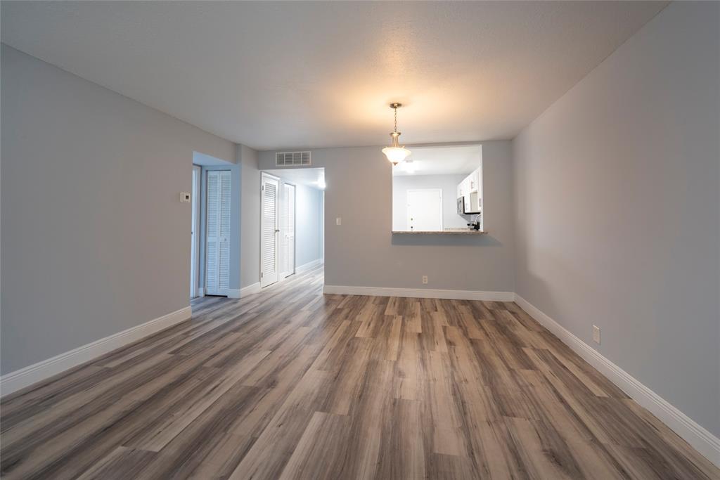 6061 North Falls Cir Drive, Unit 102 Lauderhill, FL 33319 - Photo 10 of 26 wooden floor in an empty room with a window