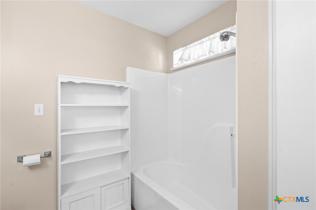 409 Newhaven Street Victoria, TX 77904 - Photo 13 of 28 a view of walk in closet with empty racks