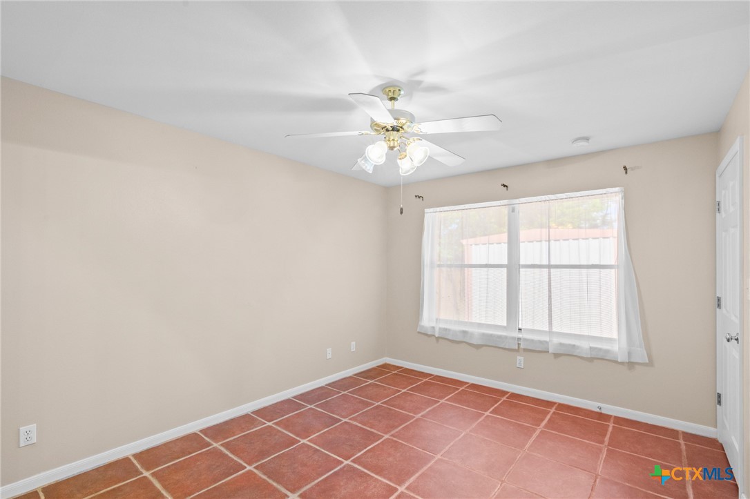 409 Newhaven Street Victoria, TX 77904 - Photo 14 of 28 an empty room with chandelier fan and windows