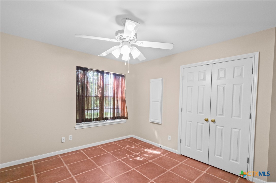 409 Newhaven Street Victoria, TX 77904 - Photo 18 of 28 an empty room with windows and fan