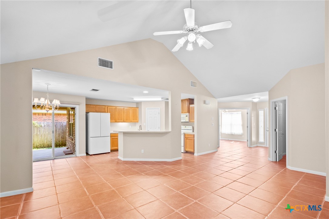 409 Newhaven Street Victoria, TX 77904 - Photo 2 of 28 a view of a big room with windows and chandelier fan