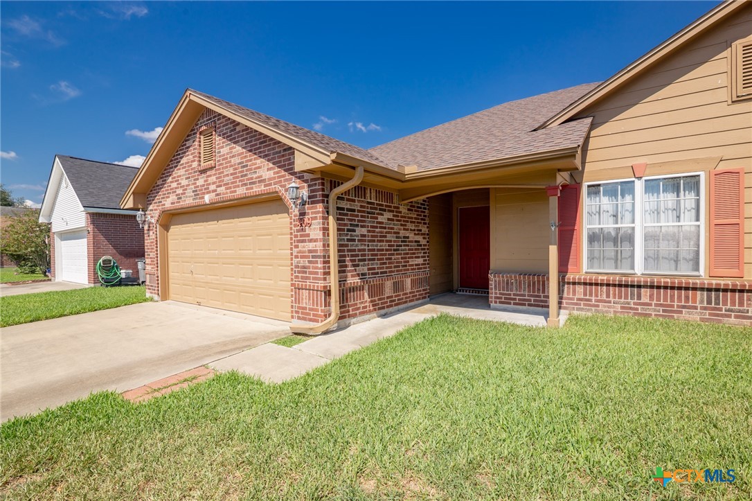 409 Newhaven Street Victoria, TX 77904 - Photo 21 of 28 a front view of a house with a yard and garage