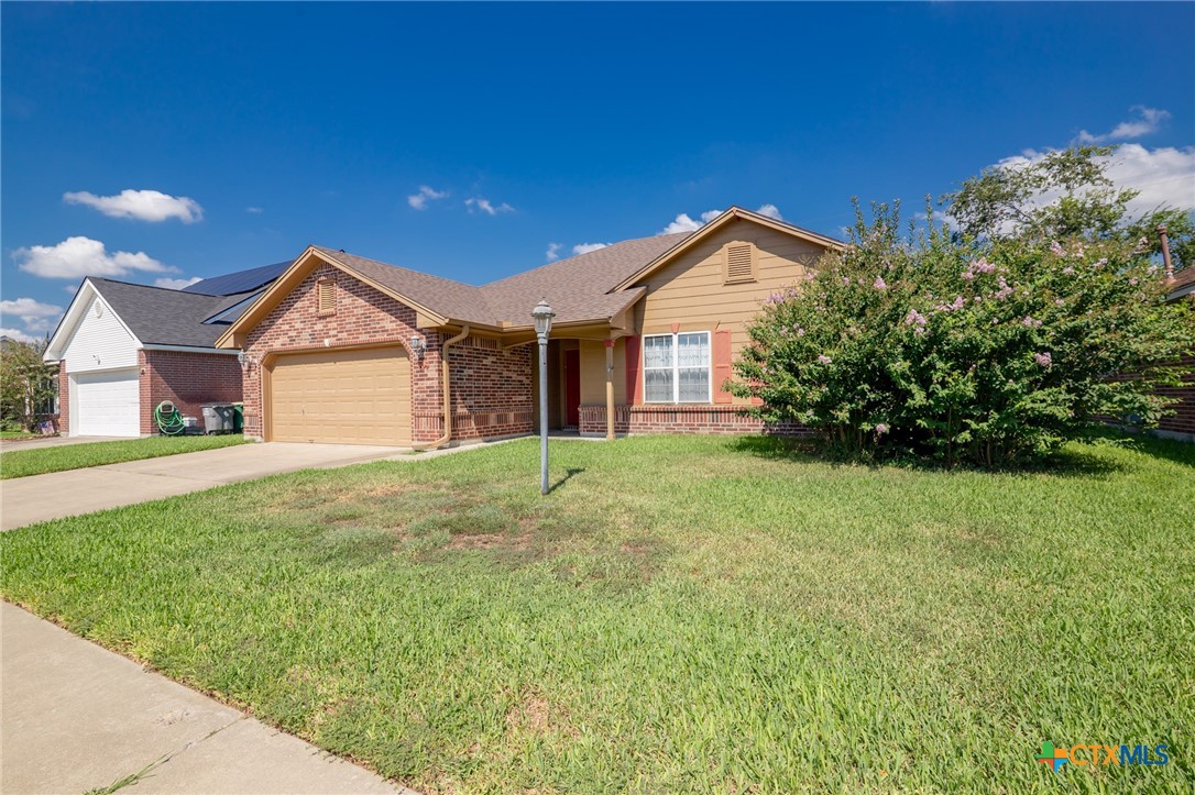 409 Newhaven Street Victoria, TX 77904 - Photo 22 of 28 a view of a house with a yard and large tree